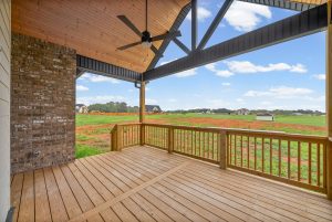 Covered back deck with spacious lot view