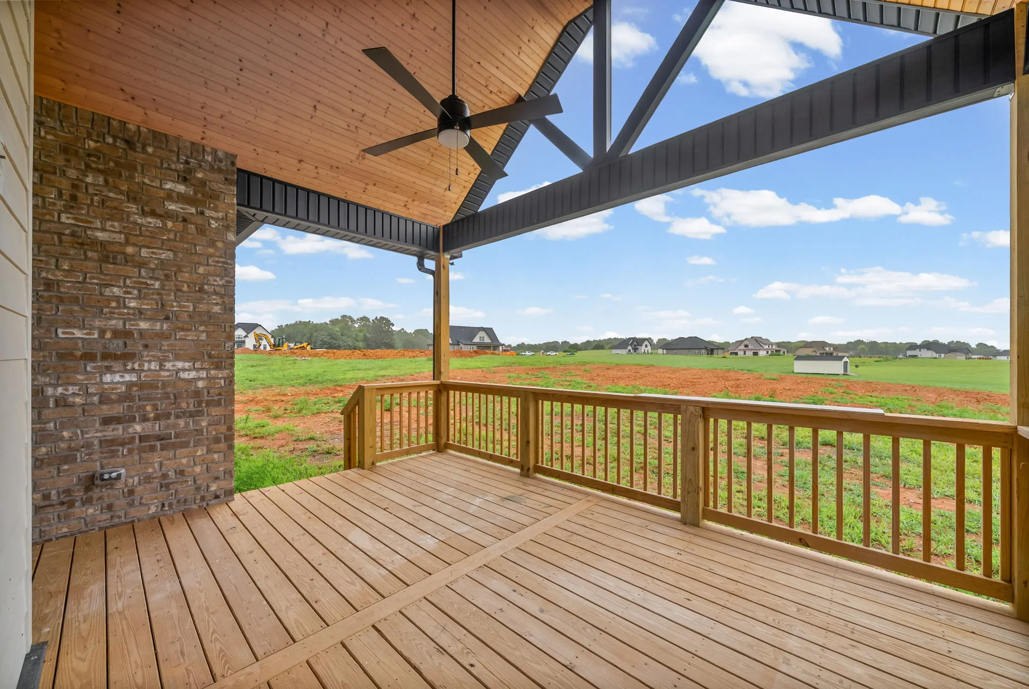 Covered back deck with spacious lot view